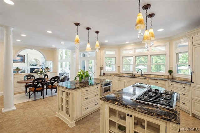 203 Randolph Square Ln, Richmond, VA 23238 - kitchen with cream cabinetry, a center island, stainless steel appliances, glass insert cabinets, and dark stone countertops