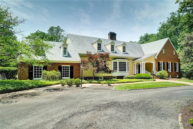 3320 Traylor Dr, Richmond, VA 23235 - cape cod-style house featuring a chimney and brick siding