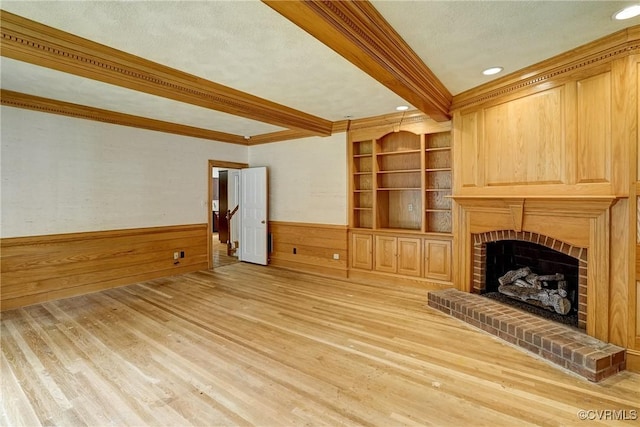 3320 Traylor Dr, Richmond, VA 23235 - unfurnished living room with ornamental molding, beamed ceiling, light wood finished floors, a brick fireplace, and a textured ceiling