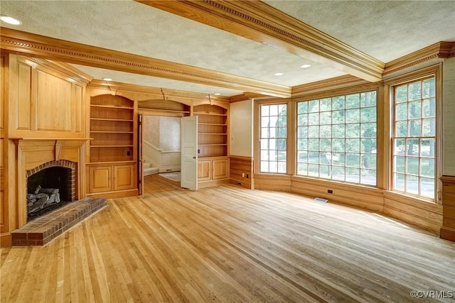 3320 Traylor Dr, Richmond, VA 23235 - unfurnished living room with ornamental molding, beamed ceiling, light wood finished floors, a brick fireplace, and a textured ceiling