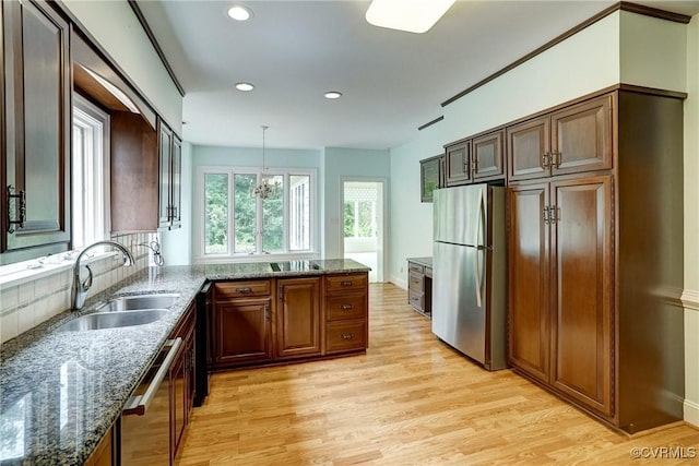 3320 Traylor Dr, Richmond, VA 23235 - kitchen featuring stainless steel appliances, a sink, light wood-style flooring, recessed lighting, and dark stone counters
