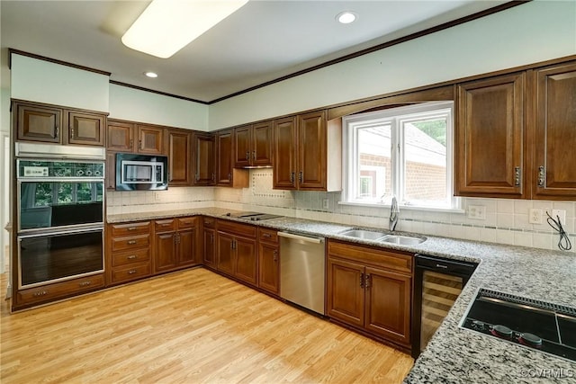 3320 Traylor Dr, Richmond, VA 23235 - kitchen with appliances with stainless steel finishes, a sink, light wood finished floors, backsplash, and recessed lighting