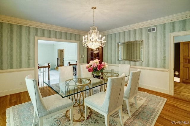 3320 Traylor Dr, Richmond, VA 23235 - dining room with wallpapered walls, a chandelier, wood finished floors, wainscoting, and ornamental molding