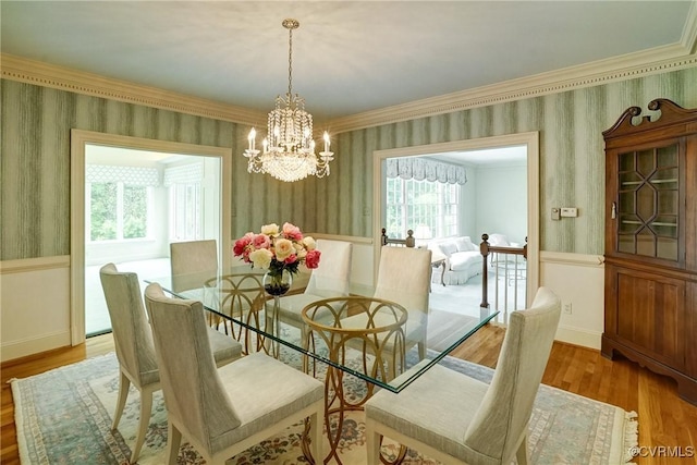 3320 Traylor Dr, Richmond, VA 23235 - dining room featuring wallpapered walls, a chandelier, crown molding, wainscoting, and wood finished floors