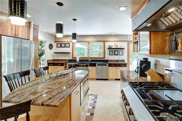 2940 Queenswood Rd, Midlothian, VA 23113 - kitchen featuring appliances with stainless steel finishes, wall chimney range hood, light tile patterned flooring, dark stone counters, and pendant lighting