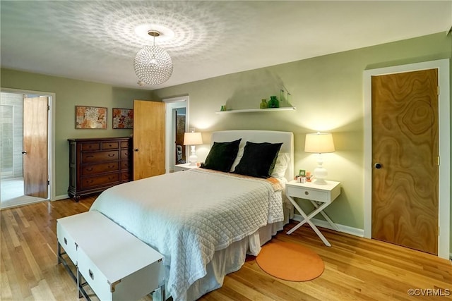 2940 Queenswood Rd, Midlothian, VA 23113 - bedroom with baseboards, wood finished floors, and a chandelier