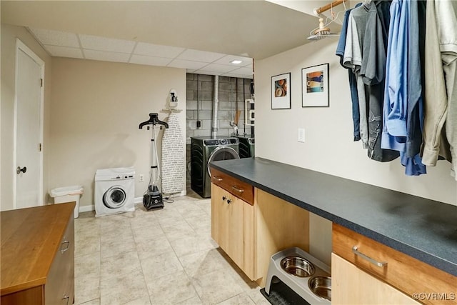 2940 Queenswood Rd, Midlothian, VA 23113 - kitchen with washer and clothes dryer, a paneled ceiling, light tile patterned floors, and baseboards