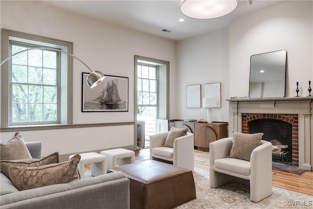 2311 E Broad St, Richmond, VA 23223 - living area with light wood-type flooring and a brick fireplace