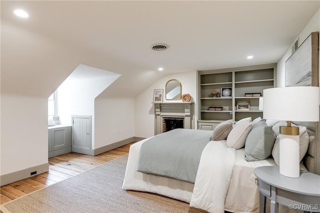 2311 E Broad St, Richmond, VA 23223 - bedroom featuring light wood-type flooring, recessed lighting, lofted ceiling, and baseboards