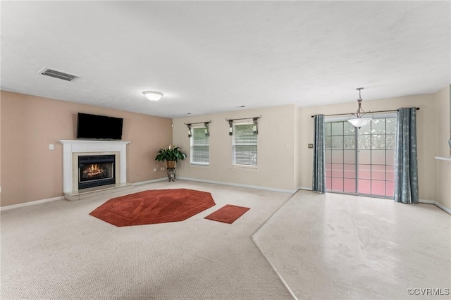 2808 Yellow Wing Ct, Henrico, VA 23231 - unfurnished living room with plenty of natural light, a lit fireplace, baseboards, and carpet floors