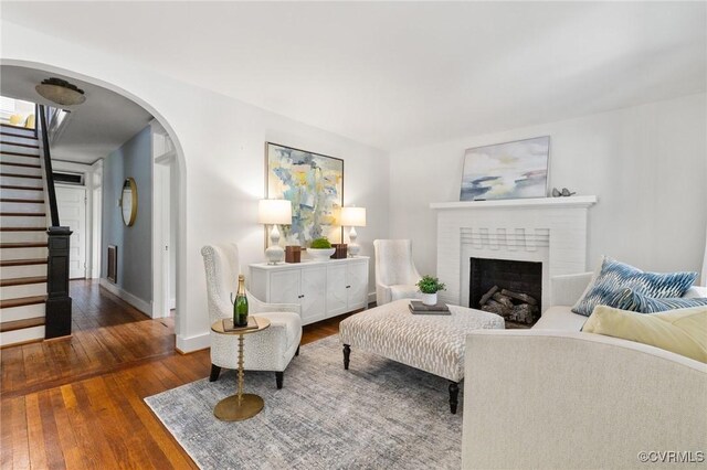 4500 Forest Hill Ave, Richmond, VA 23225 - living area featuring stairway, arched walkways, hardwood / wood-style flooring, and baseboards