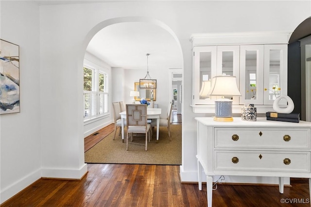4500 Forest Hill Ave, Richmond, VA 23225 - dining area with arched walkways, dark wood-style floors, and baseboards