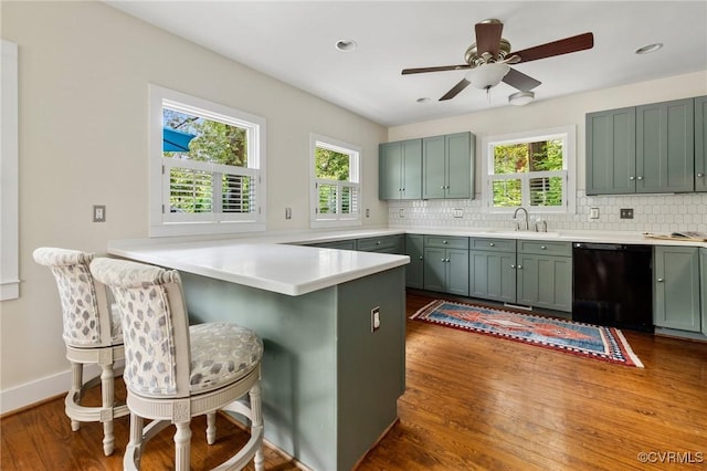4500 Forest Hill Ave, Richmond, VA 23225 - kitchen with black dishwasher, a peninsula, decorative backsplash, plenty of natural light, and recessed lighting