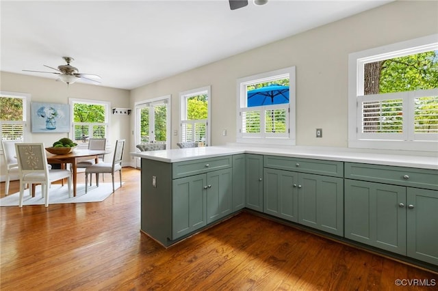4500 Forest Hill Ave, Richmond, VA 23225 - kitchen featuring green cabinets, ceiling fan, light countertops, a peninsula, and dark wood finished floors