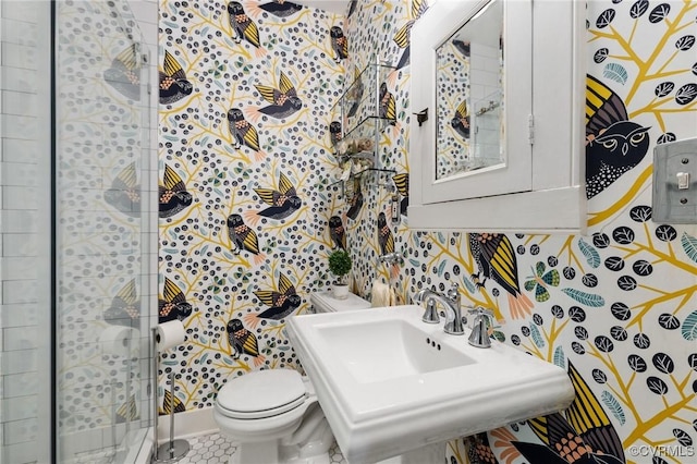 4500 Forest Hill Ave, Richmond, VA 23225 - bathroom featuring a stall shower, toilet, wallpapered walls, tile patterned flooring, and a sink