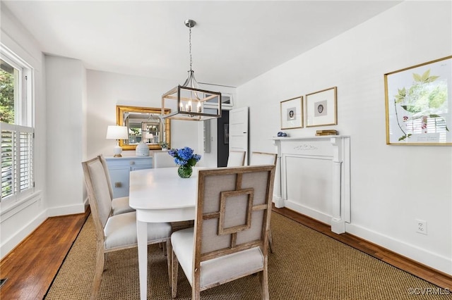 4500 Forest Hill Ave, Richmond, VA 23225 - dining area featuring wood finished floors, a chandelier, and baseboards