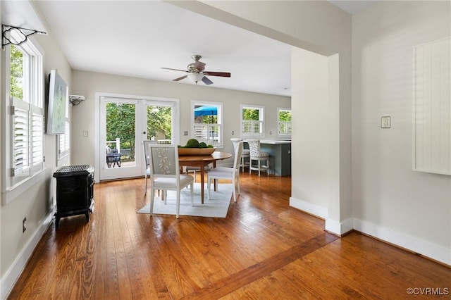 4500 Forest Hill Ave, Richmond, VA 23225 - dining area featuring a wood stove, hardwood / wood-style floors, ceiling fan, and baseboards