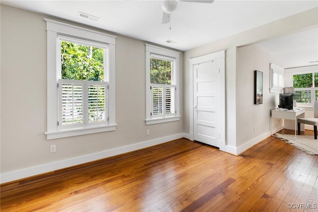 4500 Forest Hill Ave, Richmond, VA 23225 - unfurnished room with hardwood / wood-style floors, a ceiling fan, baseboards, and a desk
