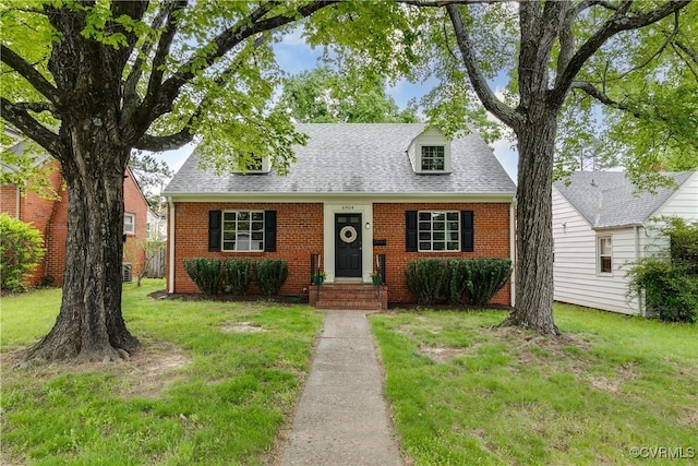 6904 Three Chopt Rd, Richmond, VA 23226 - cape cod home with brick siding, a front lawn, and roof with shingles