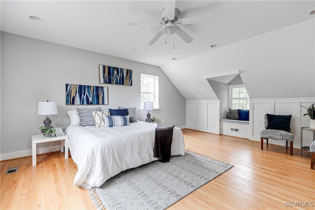 6904 Three Chopt Rd, Richmond, VA 23226 - bedroom featuring multiple windows, light wood-type flooring, vaulted ceiling, a ceiling fan, and baseboards