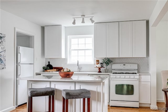 6904 Three Chopt Rd, Richmond, VA 23226 - kitchen with white appliances, tasteful backsplash, light countertops, and white cabinetry