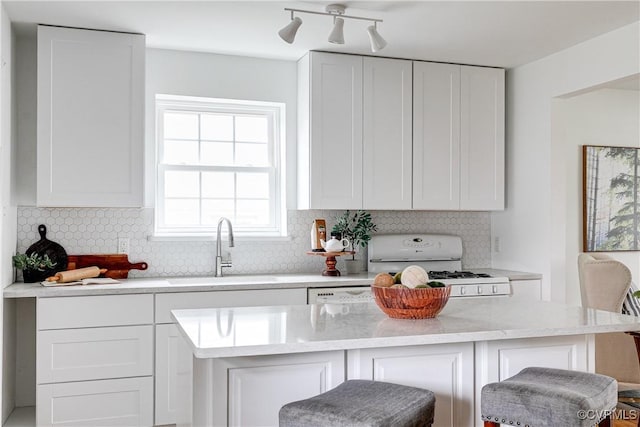 6904 Three Chopt Rd, Richmond, VA 23226 - kitchen with a sink, white gas range, white cabinets, and backsplash