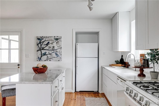 6904 Three Chopt Rd, Richmond, VA 23226 - kitchen with white appliances, light wood-style flooring, healthy amount of natural light, and a sink