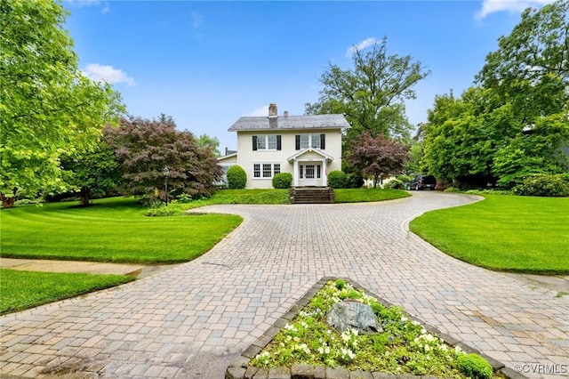 1601 Princeton Rd, Richmond, VA 23227 - view of front of home featuring curved driveway, stucco siding, a chimney, and a front lawn