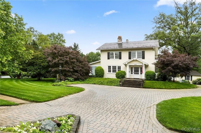 1601 Princeton Rd, Richmond, VA 23227 - view of front of property featuring a chimney, a front yard, curved driveway, and stucco siding