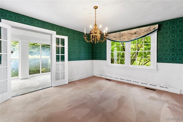 1601 Princeton Rd, Richmond, VA 23227 - carpeted empty room featuring wallpapered walls, a chandelier, wainscoting, a baseboard heating unit, and french doors