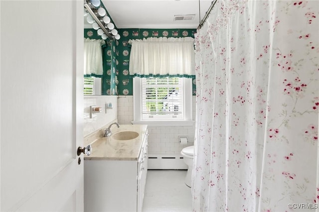 1601 Princeton Rd, Richmond, VA 23227 - bathroom with tile walls, vanity, toilet, baseboard heating, and wainscoting