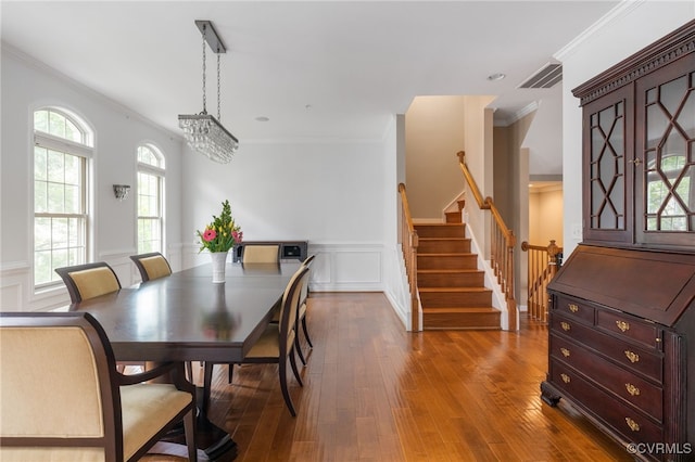 3806 Wild Goose Walk, Henrico, VA 23060 - dining area featuring crown molding, stairs, hardwood / wood-style flooring, healthy amount of natural light, and a wainscoted wall