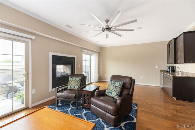 3806 Wild Goose Walk, Henrico, VA 23060 - living room with light wood-style floors, crown molding, ceiling fan, baseboards, and a multi sided fireplace