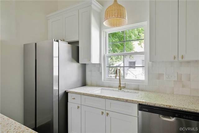 122 Elm St, Petersburg, VA 23803 - kitchen with stainless steel appliances, a sink, white cabinets, and decorative backsplash
