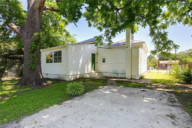 122 Elm St, Petersburg, VA 23803 - back of house featuring entry steps, solar panels, and a patio area