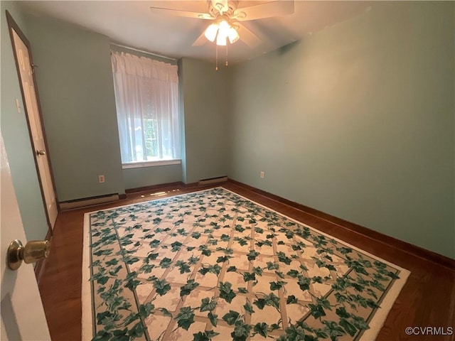 2458 Happy Hill Ln, Mechanicsville, VA 23111 - spare room with a baseboard heating unit, a ceiling fan, wood finished floors, and baseboards