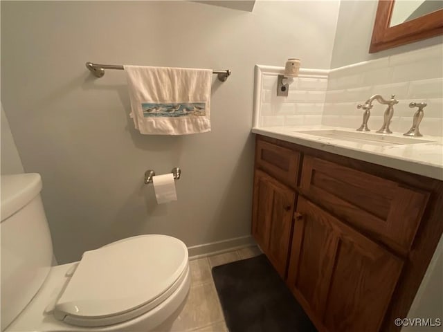 2458 Happy Hill Ln, Mechanicsville, VA 23111 - half bathroom featuring toilet, vanity, tasteful backsplash, tile patterned floors, and baseboards