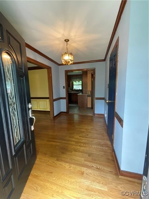 2458 Happy Hill Ln, Mechanicsville, VA 23111 - entryway with ornamental molding, a chandelier, light wood-style flooring, and baseboards