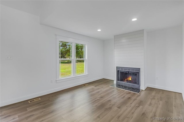647 Lakeview Dr, Heathsville, VA 22473 - unfurnished living room featuring a large fireplace, wood finished floors, baseboards, and recessed lighting