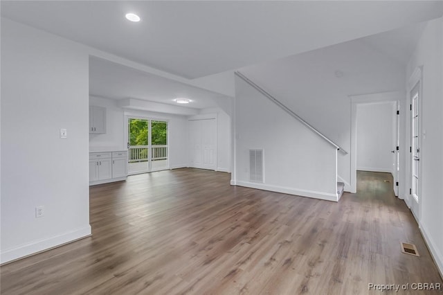 647 Lakeview Dr, Heathsville, VA 22473 - unfurnished living room featuring wood finished floors, stairs, baseboards, and recessed lighting