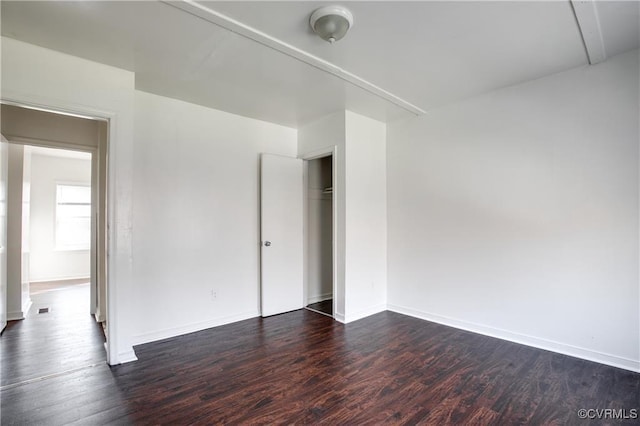 716-718 Wesley St, Petersburg, VA 23803 - unfurnished bedroom with dark wood-style flooring, baseboards, and a closet