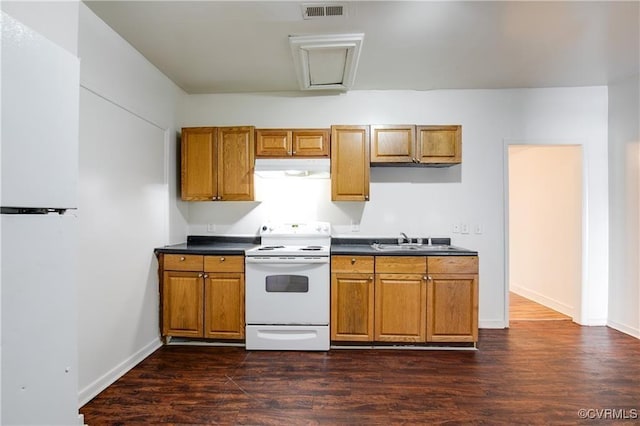 716-718 Wesley St, Petersburg, VA 23803 - kitchen with electric range, under cabinet range hood, a sink, and brown cabinetry