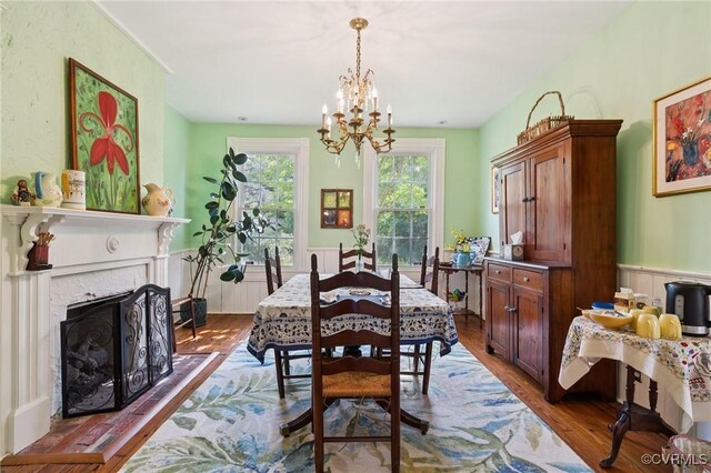 36 Carter Rd, Cumberland, VA 23040 - dining space with a chandelier, dark wood-style floors, wainscoting, and a fireplace with raised hearth