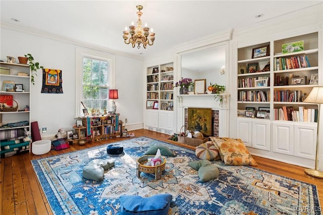 36 Carter Rd, Cumberland, VA 23040 - living area with wood-type flooring, a chandelier, built in features, ornamental molding, and a fireplace