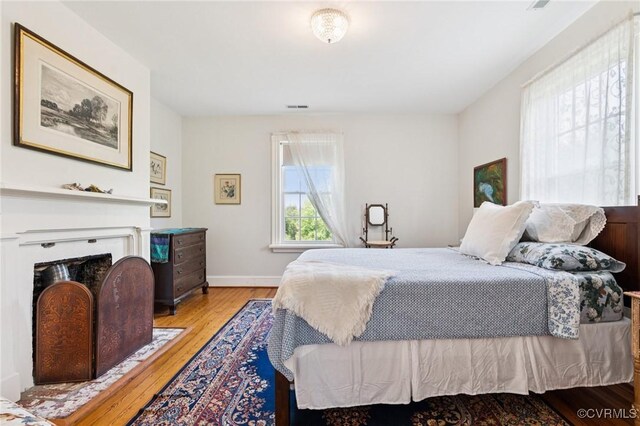 36 Carter Rd, Cumberland, VA 23040 - bedroom featuring hardwood / wood-style floors, a fireplace with flush hearth, and baseboards