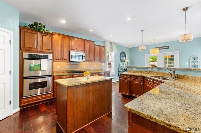 4030 Water Overlook Blvd, Midlothian, VA 23112 - kitchen with a sink, stainless steel appliances, a spacious island, light stone countertops, and dark wood-style flooring