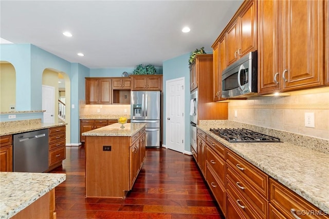 4030 Water Overlook Blvd, Midlothian, VA 23112 - kitchen with appliances with stainless steel finishes, a kitchen island, light stone countertops, dark wood-type flooring, and recessed lighting