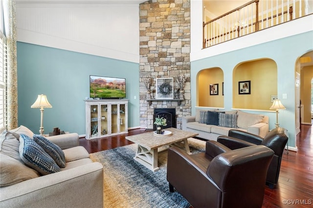4030 Water Overlook Blvd, Midlothian, VA 23112 - living area with a towering ceiling, wood finished floors, a stone fireplace, arched walkways, and baseboards