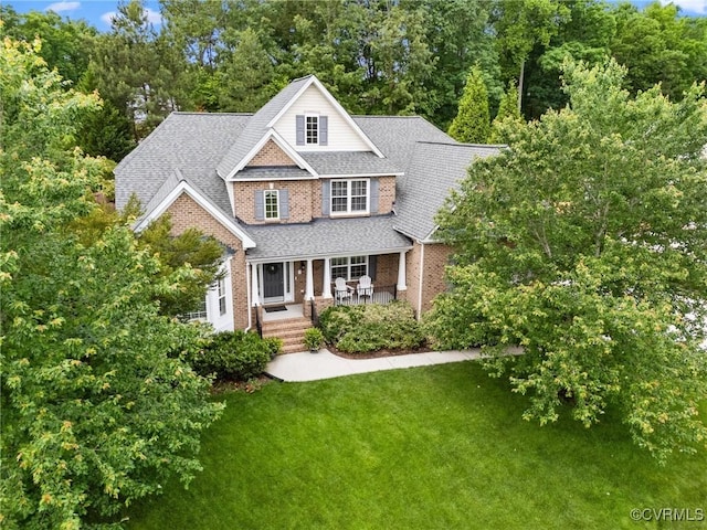 4030 Water Overlook Blvd, Midlothian, VA 23112 - view of front of home with brick siding, a front lawn, covered porch, a shingled roof, and view of scattered trees