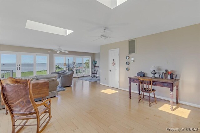 159 Fleeton Point Cir, Reedville, VA 22539 - living area with a ceiling fan, light wood-style flooring, a skylight, and baseboards